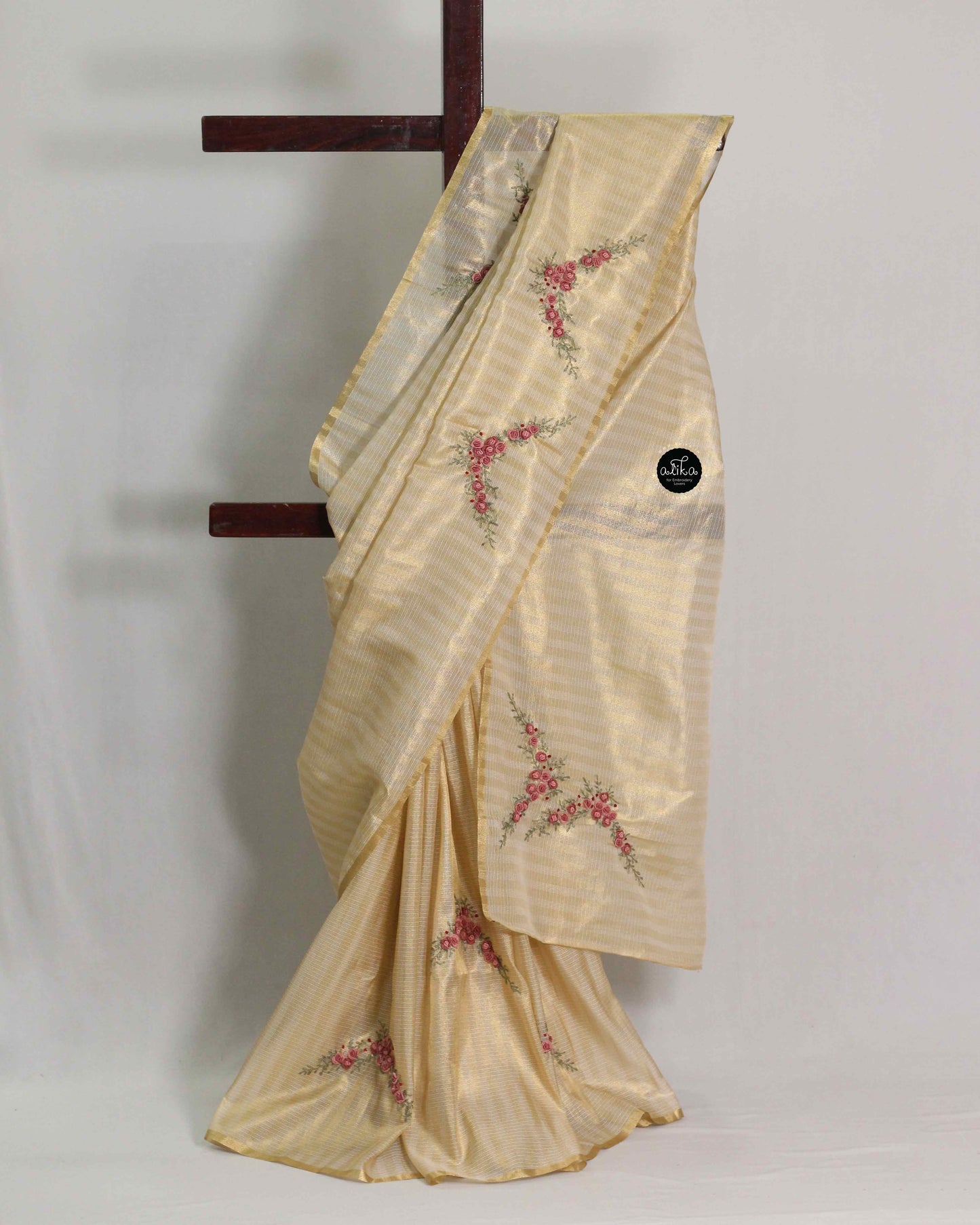 Mauve shade floral themed golden tissue saree.