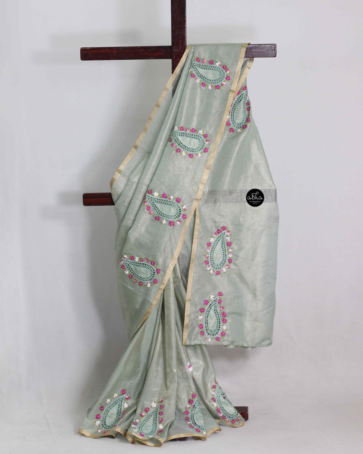 Green semi tissue saree with floral embroidery and cutwork
