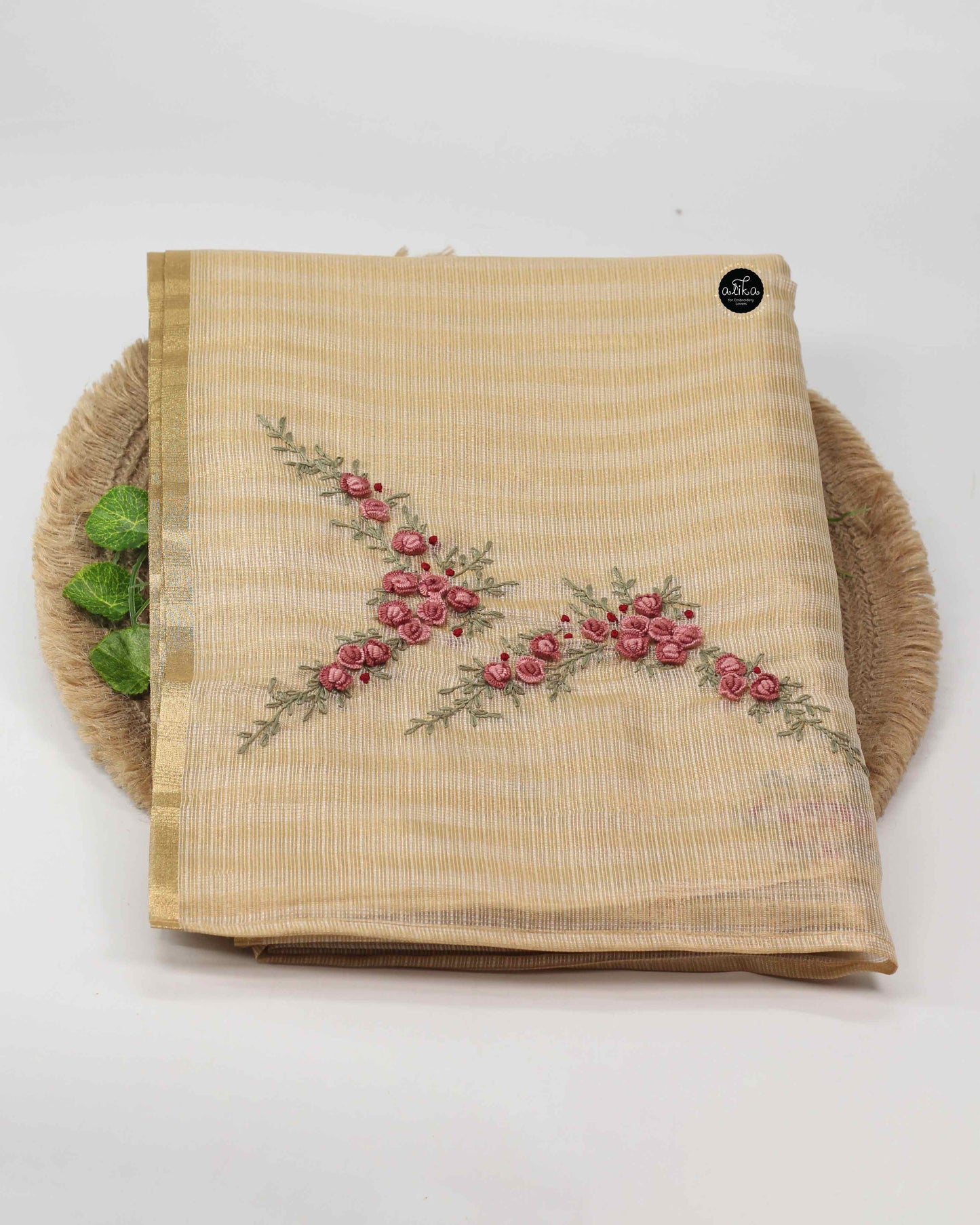 Mauve shade floral themed golden tissue saree.