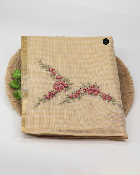 Mauve shade floral themed golden tissue saree.