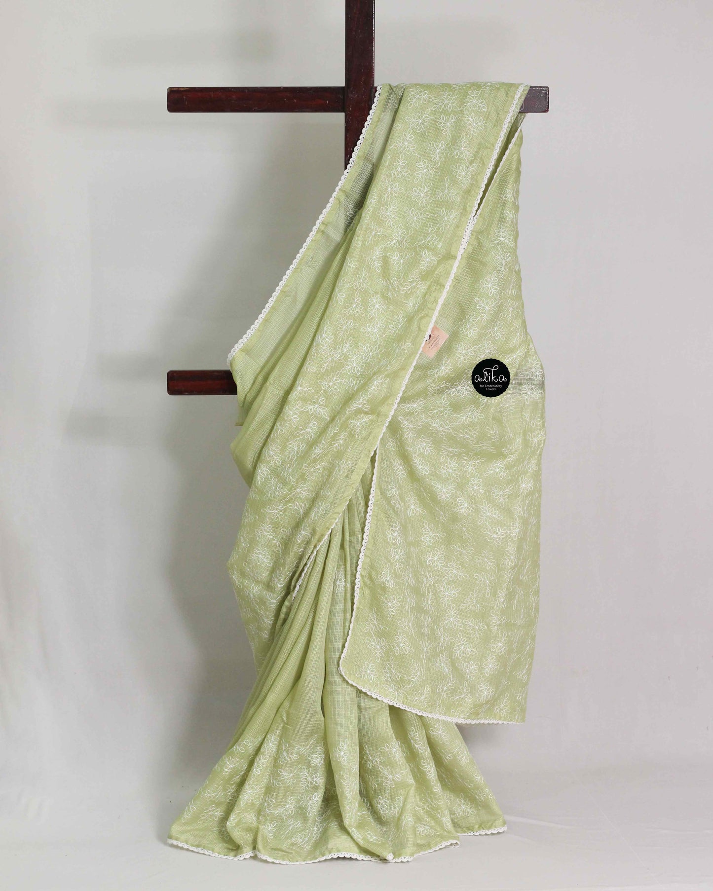 pastel green silky kota saree with floral machine embroidery and lace work