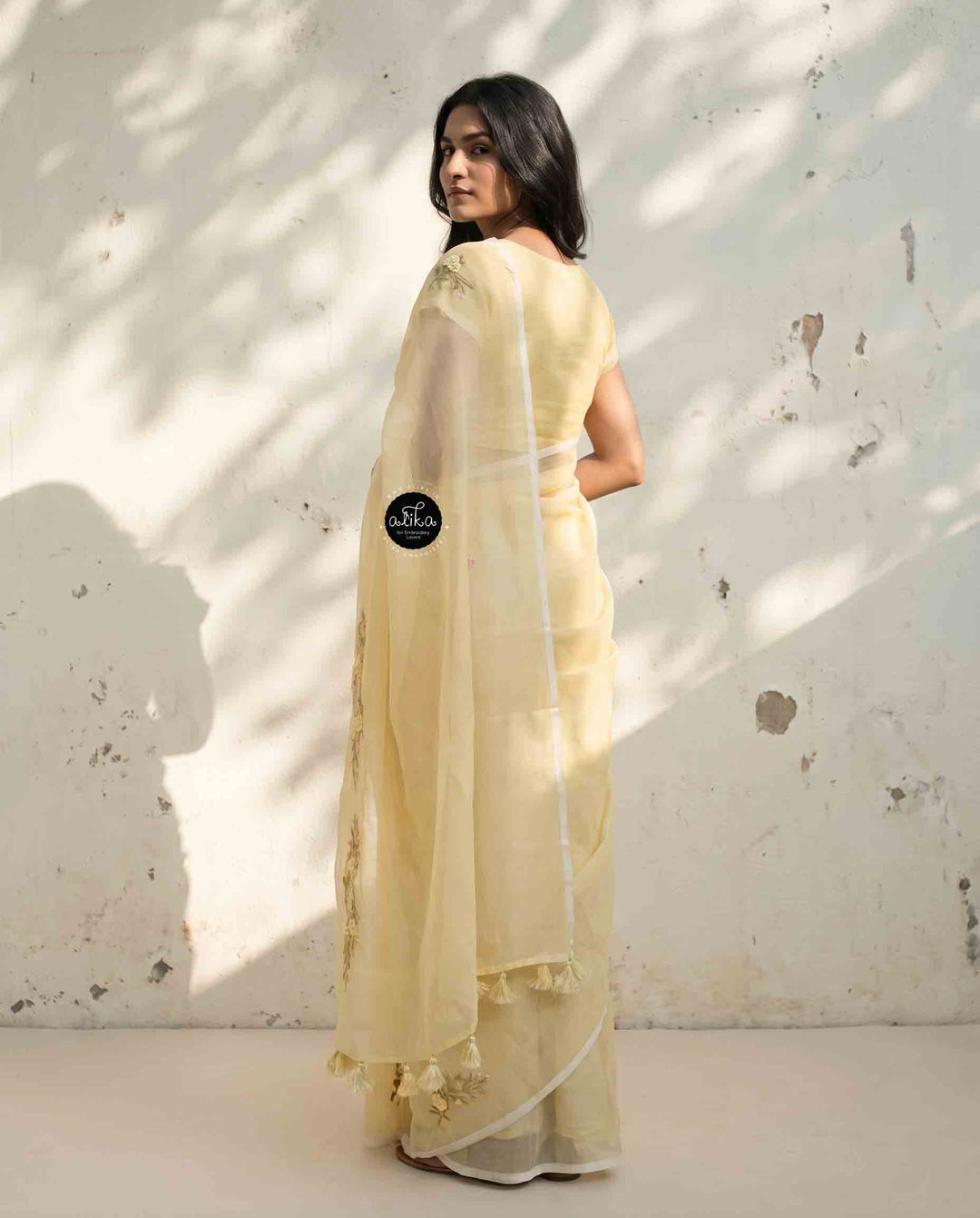 Light Yellow Kota Saree with Floral Hand Embroidery and tassels