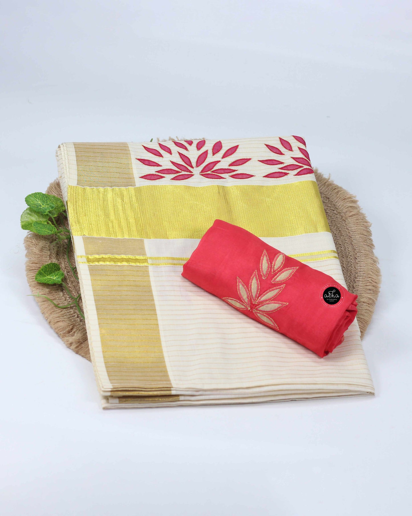 Kerala kasavu saree with floral applique work and contrast blouse piece