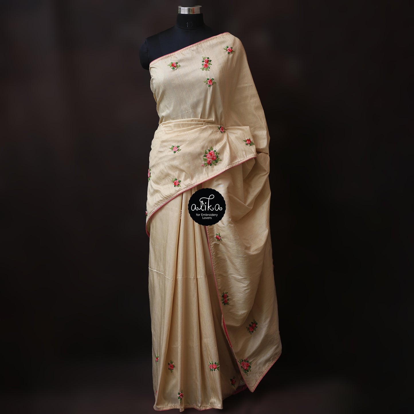 Golden beige raw silk saree with cast on floral hand embroidery and bead embellishments scattered across saree