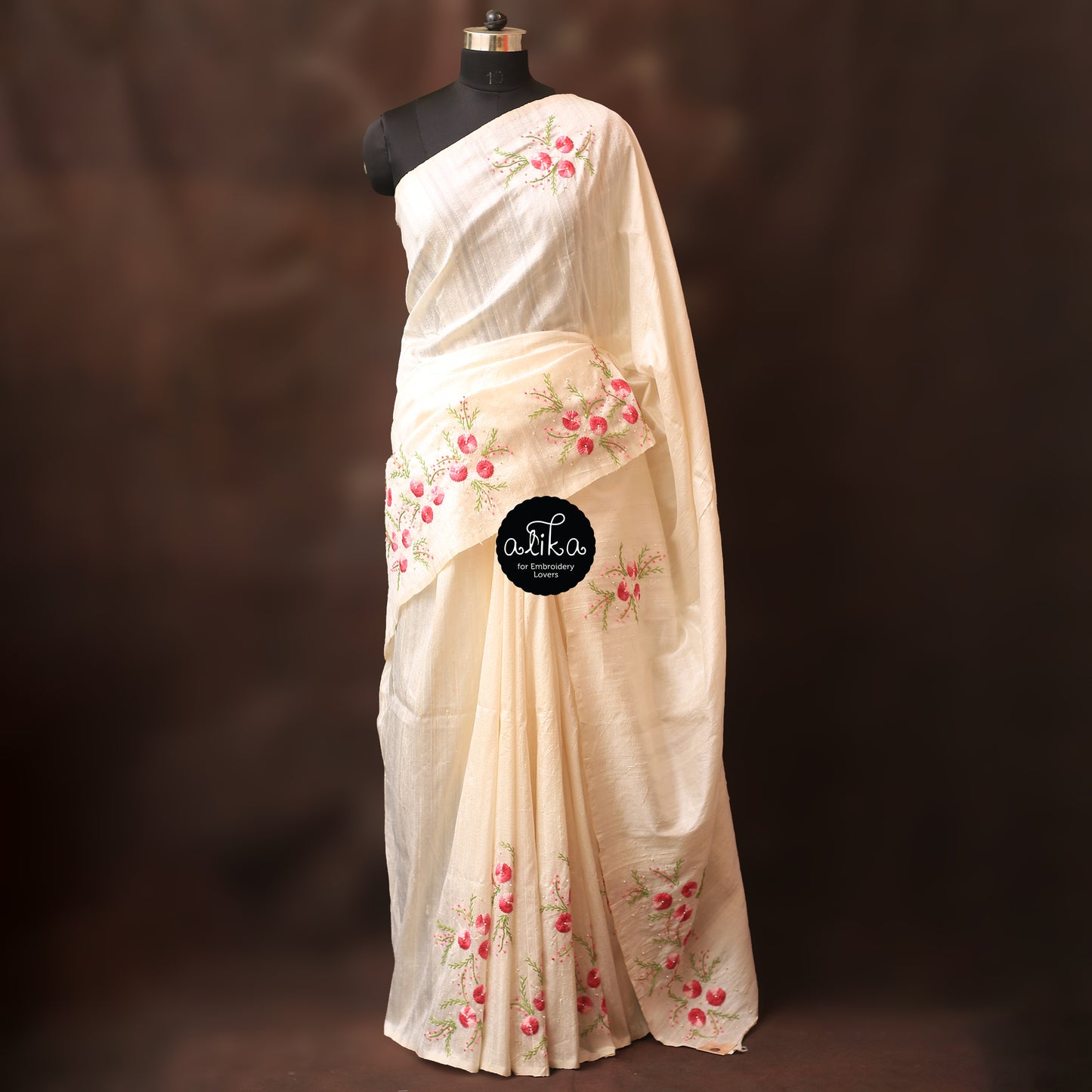 Milky white raw silk saree with hand embroidery and bead embellishments scattered across saree